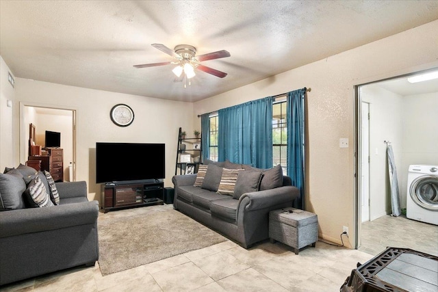 tiled living room with washer / clothes dryer, ceiling fan, and a textured ceiling