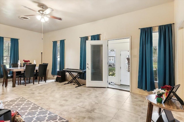 foyer entrance featuring light tile patterned floors, plenty of natural light, and ceiling fan