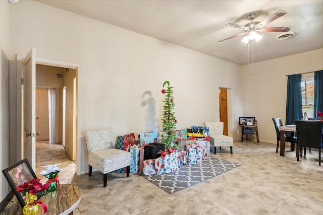 living area with ceiling fan