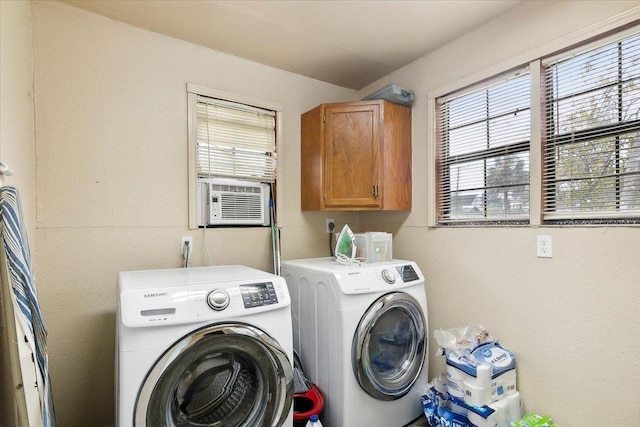 washroom with washer and dryer, cooling unit, and cabinets