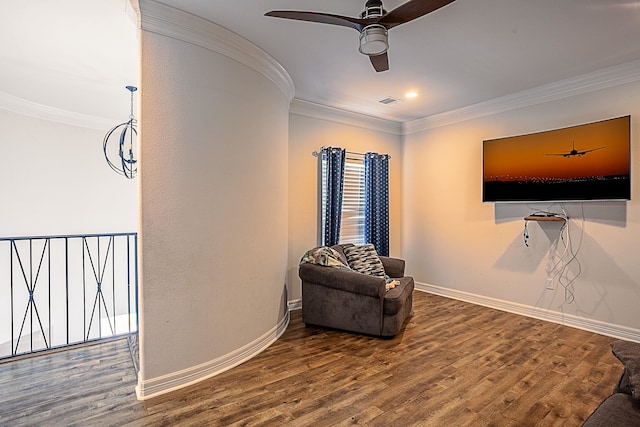 living area with hardwood / wood-style floors, ceiling fan, and crown molding