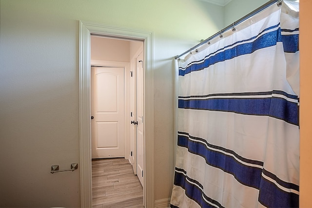 bathroom with hardwood / wood-style floors and curtained shower