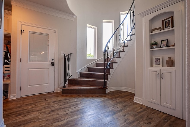 foyer entrance featuring dark hardwood / wood-style floors and crown molding