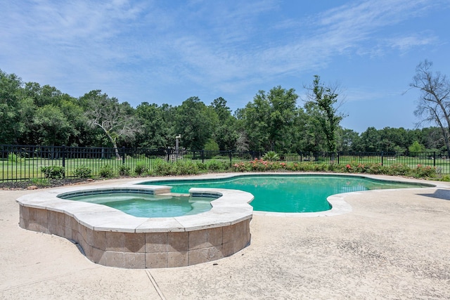 view of swimming pool with an in ground hot tub