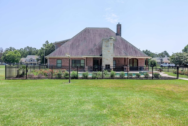 rear view of house with a lawn