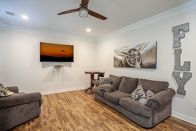 living room featuring ceiling fan, wood-type flooring, and ornamental molding