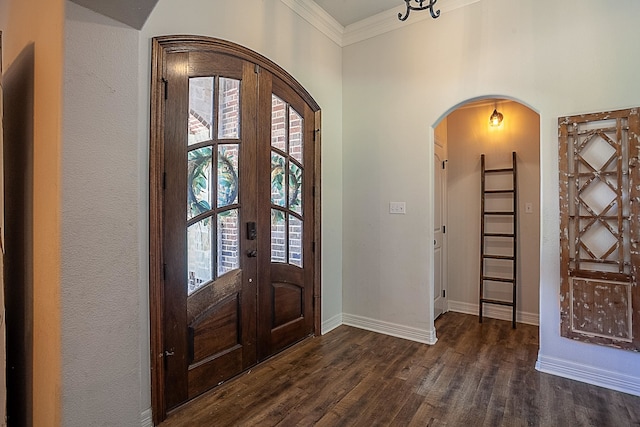 entryway featuring french doors, dark wood-type flooring, crown molding, and a healthy amount of sunlight