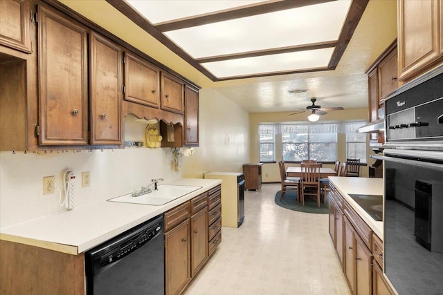 kitchen with ceiling fan, sink, black appliances, and a textured ceiling