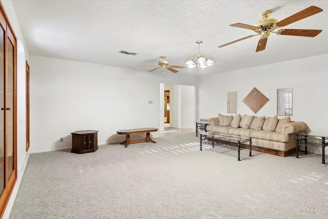 living room with carpet, a textured ceiling, and ceiling fan with notable chandelier