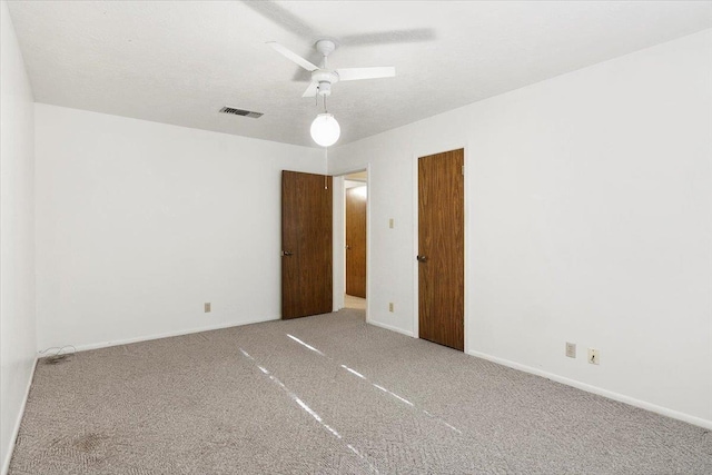 spare room with ceiling fan and carpet floors