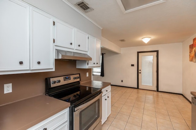 5780 Kristin Ln, Beaumont, TX 77713 - kitchen featuring stainless steel electric range, under cabinet range hood, white cabinetry, and light tile patterned flooring