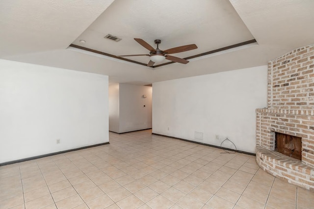 5780 Kristin Ln, Beaumont, TX 77713 - unfurnished living room with a raised ceiling, ceiling fan, and a brick fireplace