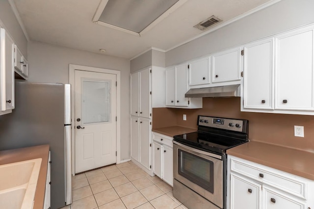 5780 Kristin Ln, Beaumont, TX 77713 - kitchen featuring appliances with stainless steel finishes, under cabinet range hood, white cabinetry, and light tile patterned flooring