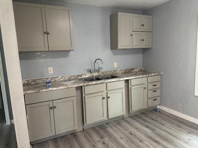 355 Chesser Dr, Vidor, TX 77662 - kitchen featuring a sink, light wood finished floors, and baseboards