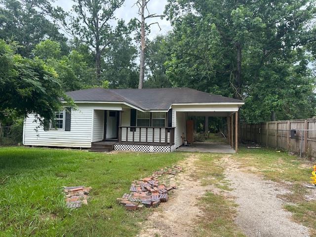 355 Chesser Dr, Vidor, TX 77662 - single story home with dirt driveway, a porch, and an attached carport