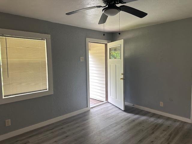 355 Chesser Dr, Vidor, TX 77662 - spare room featuring wood finished floors, ceiling fan, and baseboards