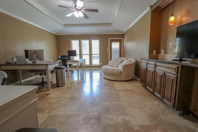 home office featuring a tray ceiling, ceiling fan, and crown molding