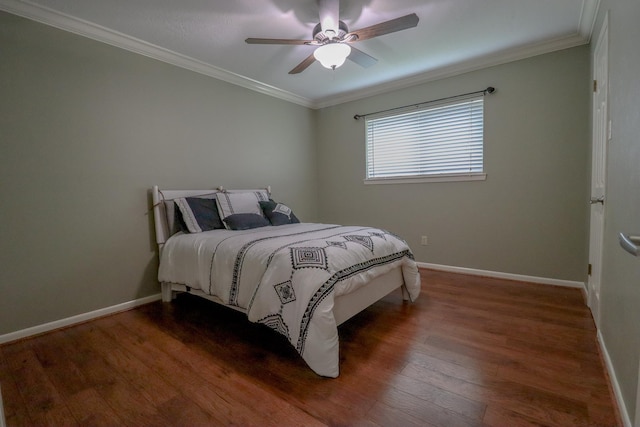 bedroom featuring dark hardwood / wood-style flooring, ceiling fan, and ornamental molding