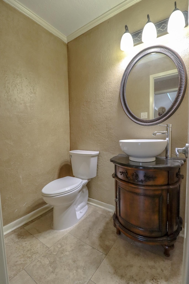 bathroom with crown molding, vanity, and toilet