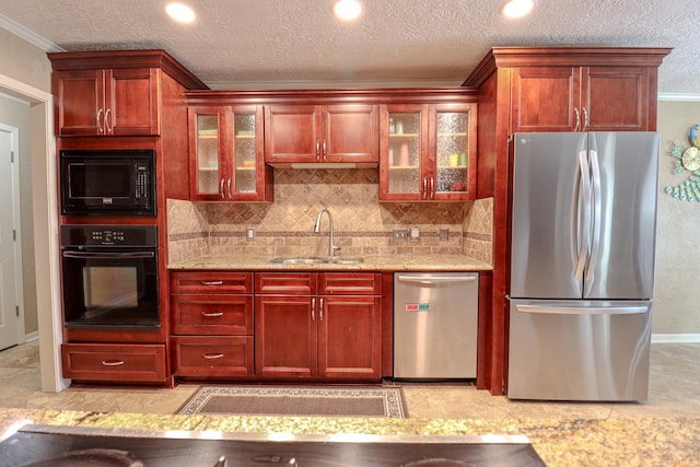 kitchen featuring light stone countertops, sink, crown molding, decorative backsplash, and black appliances