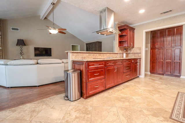 kitchen featuring backsplash, lofted ceiling with beams, ceiling fan, a textured ceiling, and island range hood