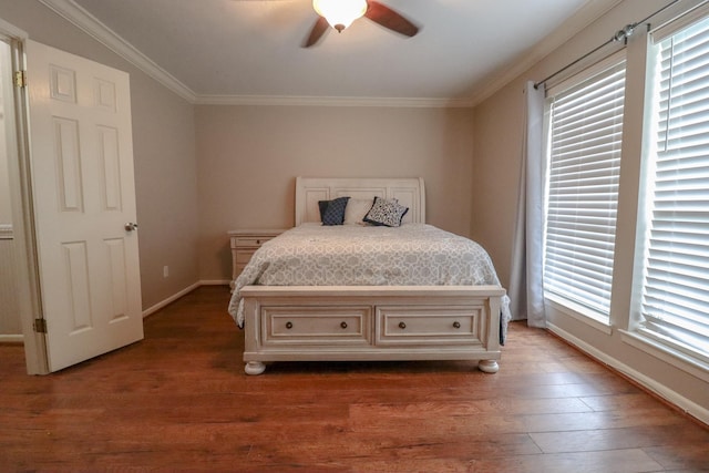 bedroom with multiple windows, ceiling fan, crown molding, and hardwood / wood-style flooring