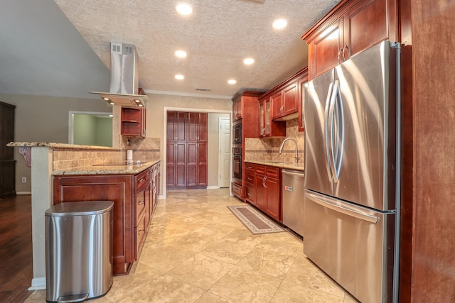 kitchen featuring sink, range hood, kitchen peninsula, decorative backsplash, and appliances with stainless steel finishes