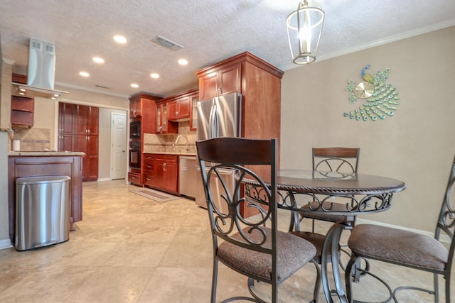 dining area featuring a textured ceiling, sink, and crown molding