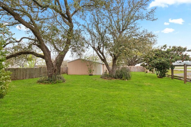 2695 Sandlin St, Beaumont, TX 77707 - fenced backyard with an outdoor structure