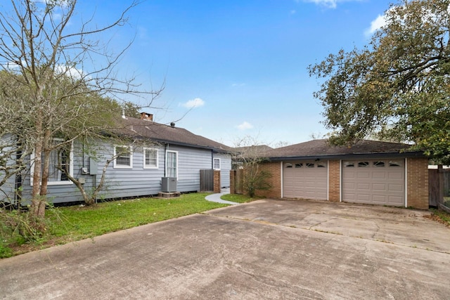 2695 Sandlin St, Beaumont, TX 77707 - view of front of home with a garage, driveway, brick siding, and a front yard