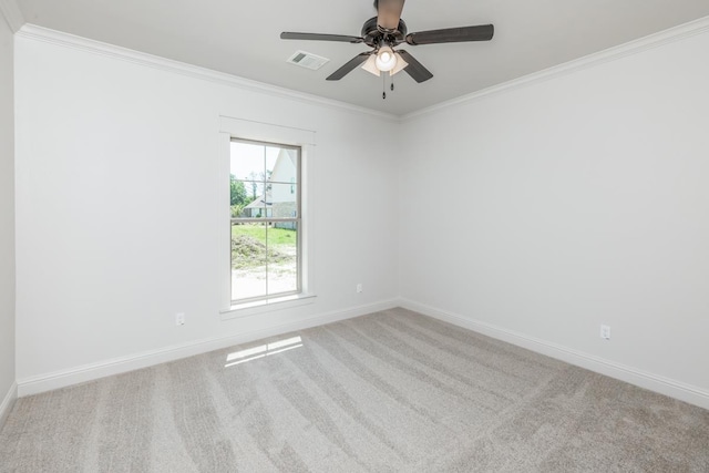 carpeted empty room with ceiling fan, baseboards, visible vents, and ornamental molding