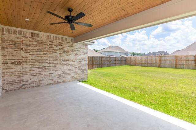 view of yard with ceiling fan, a fenced backyard, and a patio area