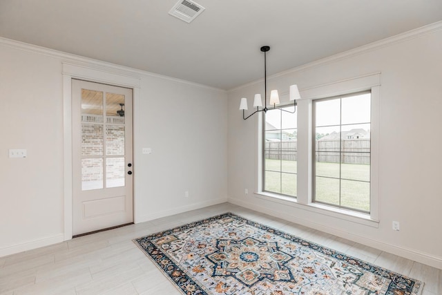 unfurnished dining area with visible vents, baseboards, ornamental molding, and an inviting chandelier