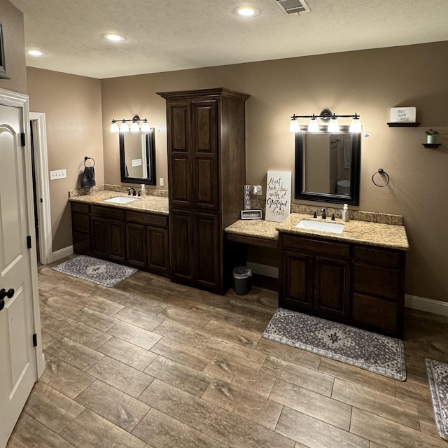 bathroom featuring vanity and a textured ceiling