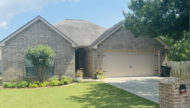 single story home with a front yard and a garage