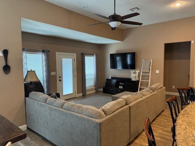 living room with light wood-type flooring and ceiling fan