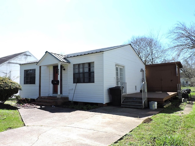 view of front of property featuring a deck and metal roof