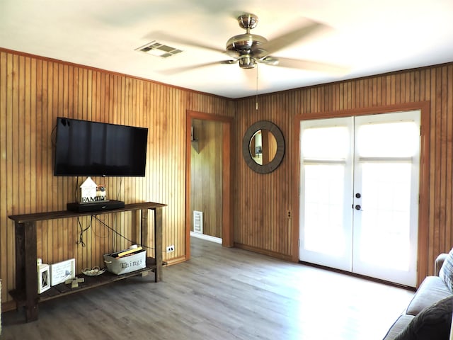 unfurnished living room featuring ceiling fan, wood finished floors, and visible vents