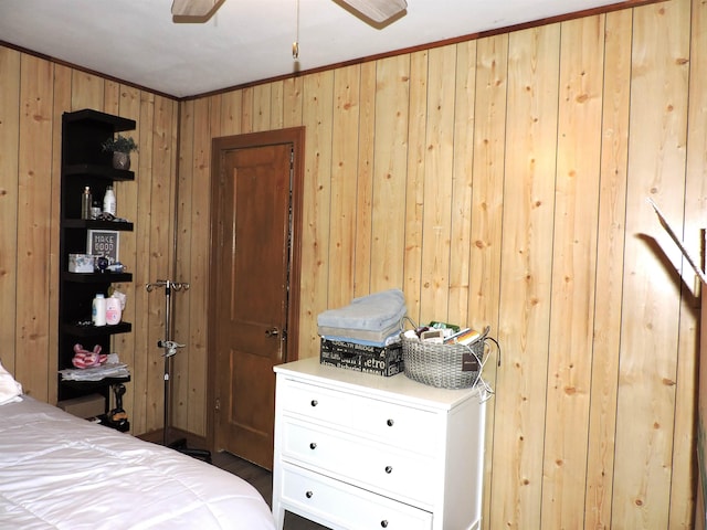 bedroom with wooden walls and crown molding