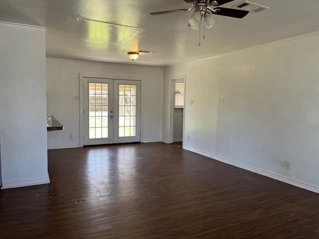 unfurnished room with baseboards, visible vents, ceiling fan, wood finished floors, and french doors