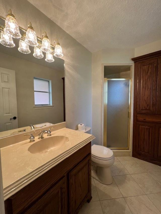 bathroom featuring toilet, a stall shower, a textured ceiling, and vanity