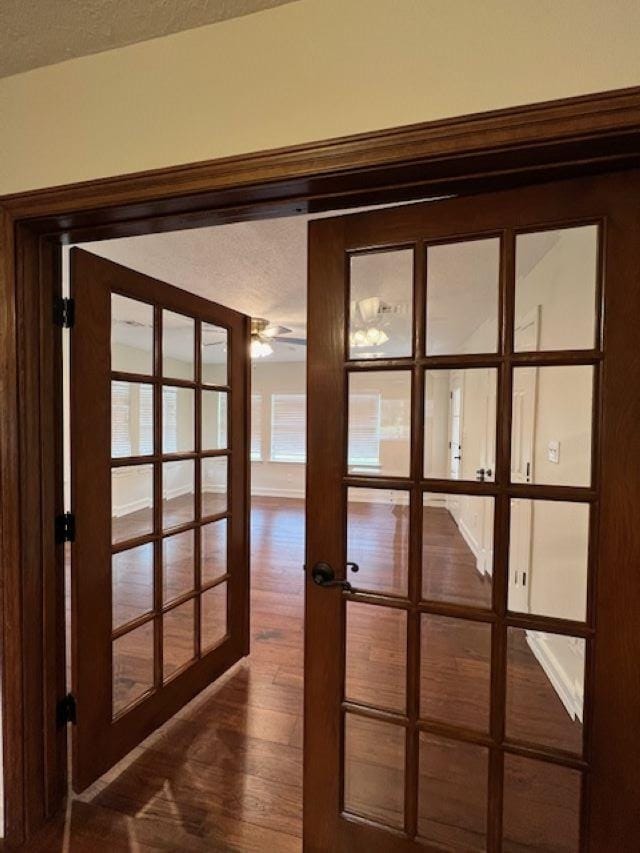 entryway featuring a textured ceiling, french doors, and wood finished floors