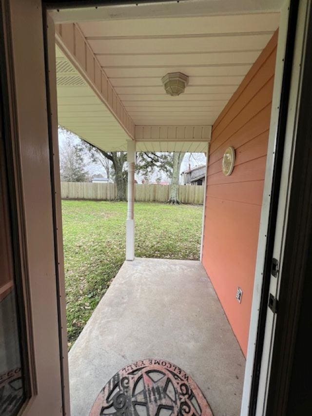 view of patio featuring fence