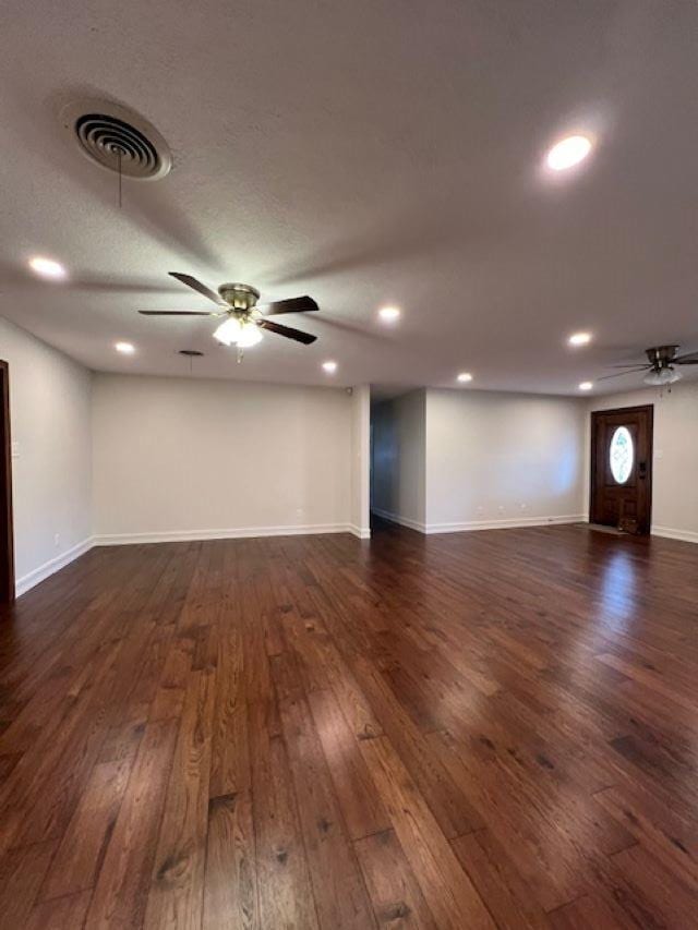 interior space featuring ceiling fan, recessed lighting, dark wood-type flooring, visible vents, and baseboards