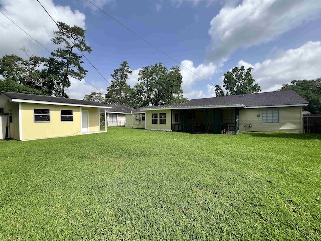 3265 N Willowood Ln, Beaumont, TX 77703 - back of house featuring a lawn