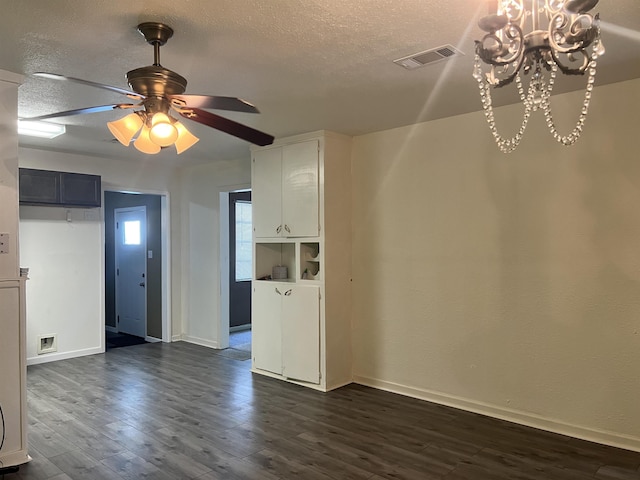 3265 N Willowood Ln, Beaumont, TX 77703 - empty room featuring dark wood finished floors, a chandelier, a ceiling fan, and a textured ceiling