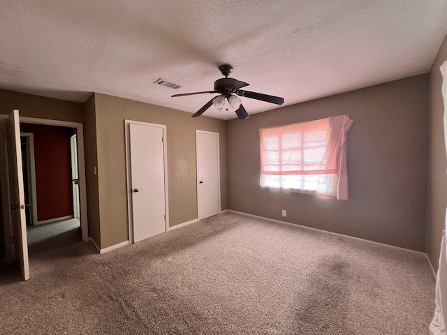 3265 N Willowood Ln, Beaumont, TX 77703 - unfurnished bedroom with carpet, a textured ceiling, and a ceiling fan