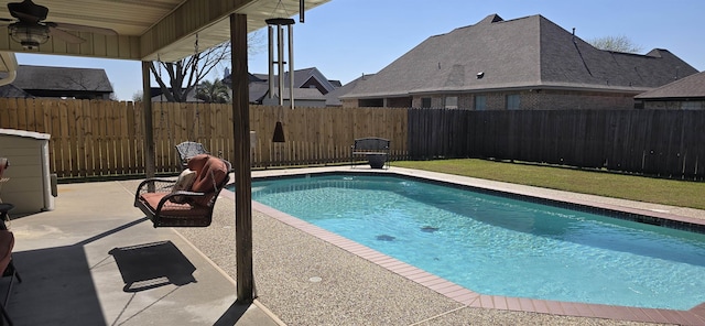 view of swimming pool with a patio area, ceiling fan, a fenced backyard, and a fenced in pool