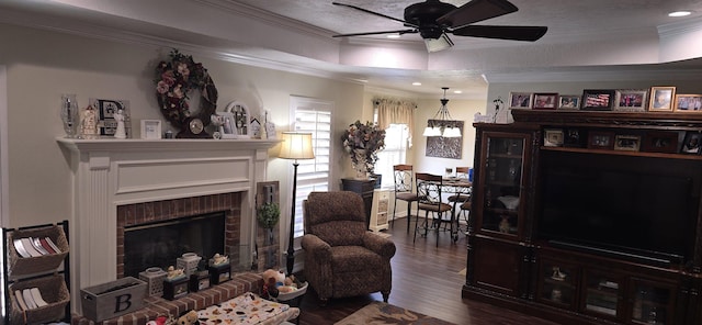 living room featuring dark wood finished floors, ornamental molding, recessed lighting, a fireplace, and a ceiling fan