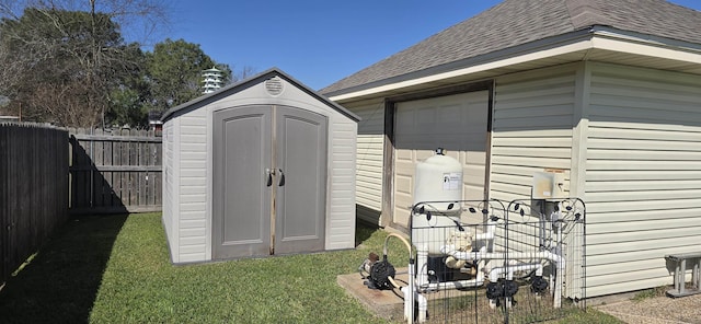 view of shed with a fenced backyard